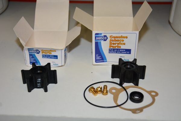 A spare impeller and whole service kit side by side