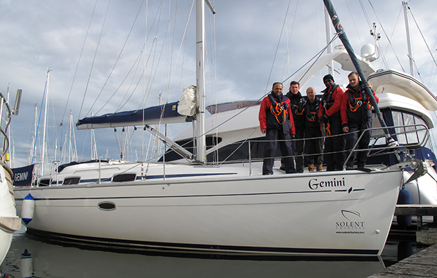 A crew of a yacht standing on the deck
