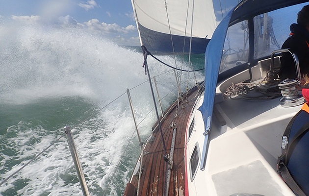 A yacht sailing through waves