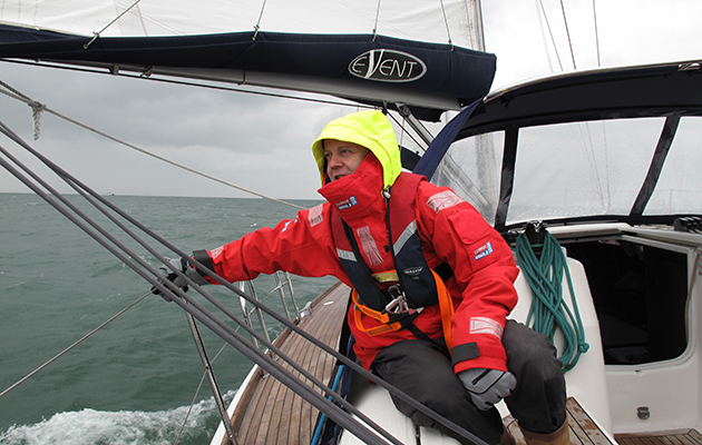 A crew member in wet weather gear