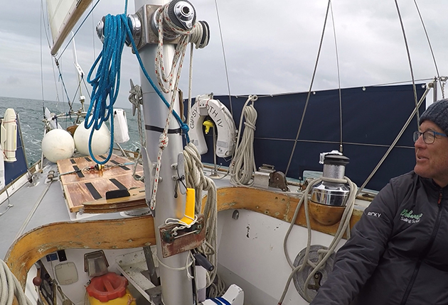 A man sitting in the cockpit of the yacht which took Sir Francis Chichester around the world in 1966-67