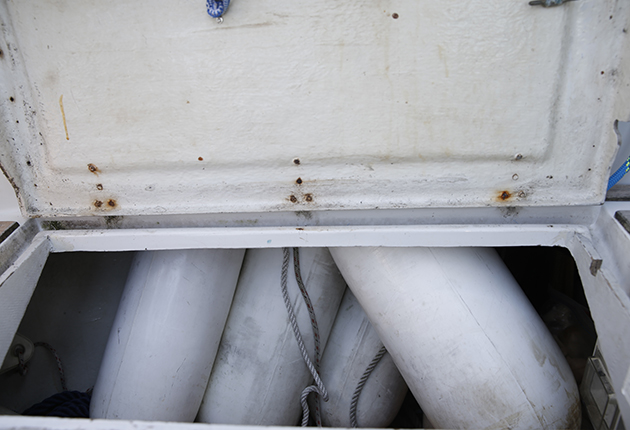Fenders in a cockpit locker on a boat