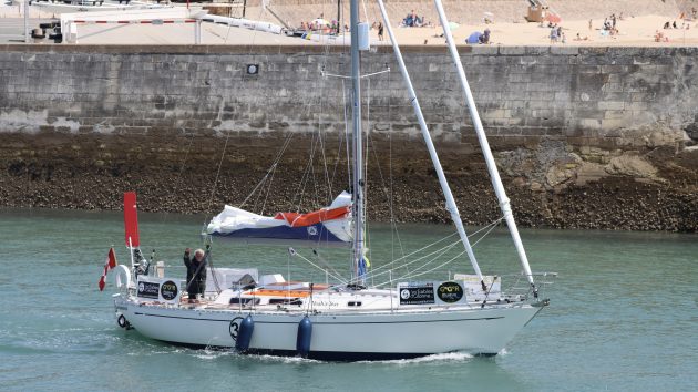 A man on a boat sailing down the channel in Les Sables d'Olonne in france