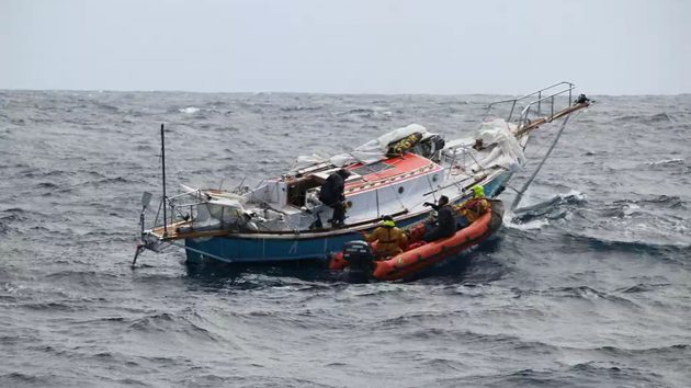 A skipper being taken over a dismasted boat