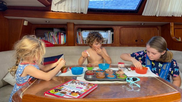 Children making cakes on a yacht