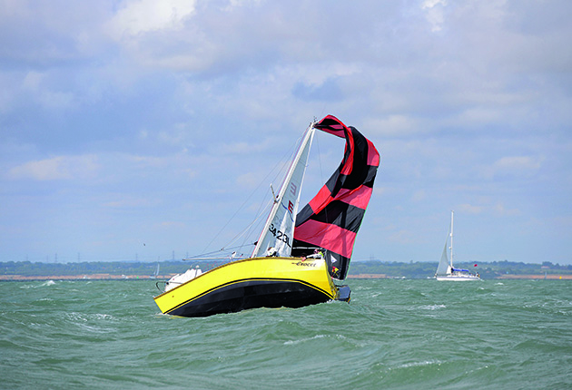 A yacht with a flapping sail