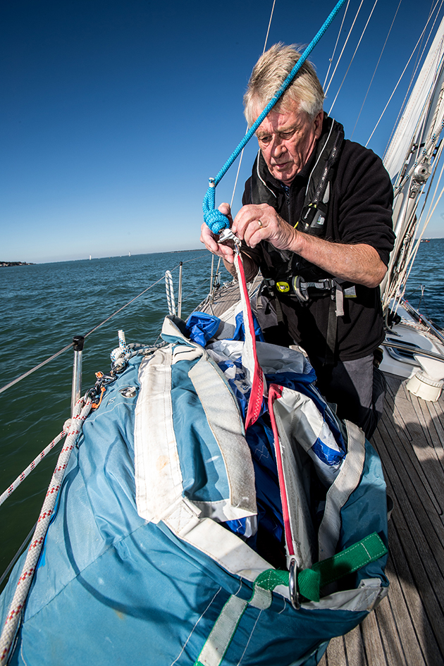 A man preparing a sail