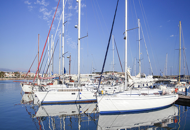 Yachts moored in a harbour under a blue sky