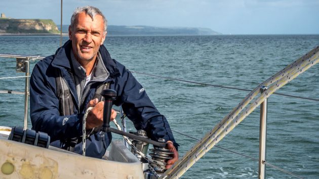 Guy Waites in a blue tshirt onboard his boat