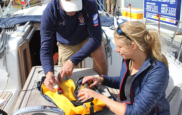 A woman checking a yellow lifejacket