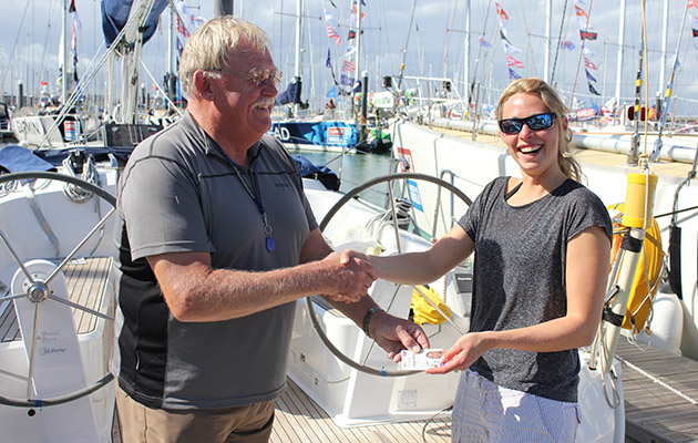 A woman being presented with a Day Skipper certificate