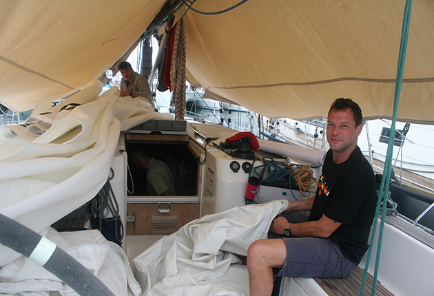 A skipper does some last-minute sail repairs in Gran Canaria before the start of the Atlantic Rally for Cruisers