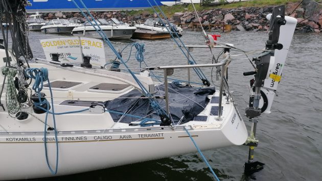 A stern of a white yacht showing a self steering system