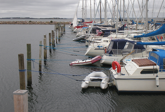 Once you're secure, if you can, cross over the stern lines so the line from the sternboard quarter goes to the port post. This will help hold the boat straight in the berth, like springs when using a box mooring