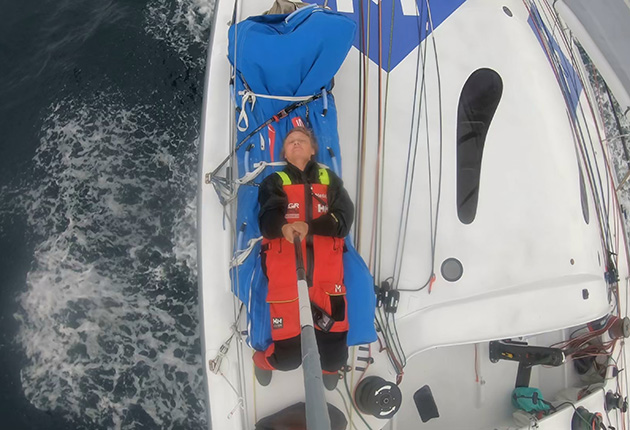 Pip lying on her back with a selfie stick onboard Medallia during the 2020 Vendee Globe