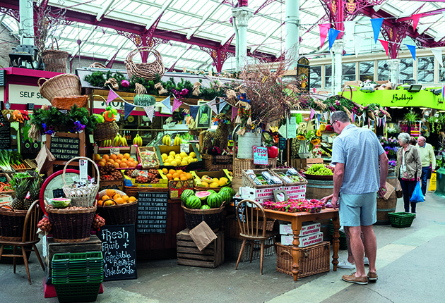People examining produce at the Central Market in Jersey