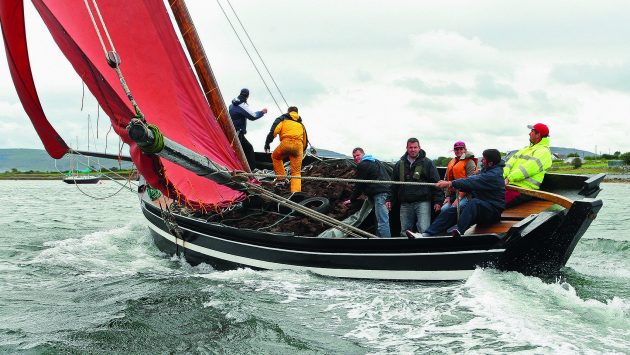 Carrying turf was one of the main functions of hookers like like An Mhaighdean Mhara (The Mermaid), seen racing at the Cruinniú na mBád. Credit: Joe O'Shaughnessy