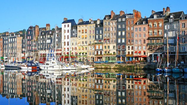 Yachts moored in front of houses in Honfleur in France