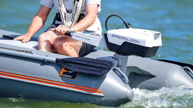 a person using an electric outboard on a grey dinghy