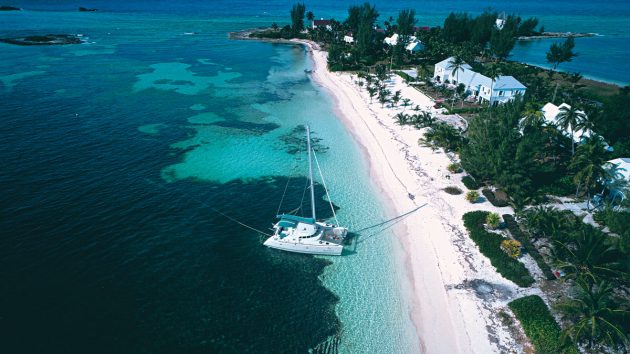 A catamaran anchored in blue waters