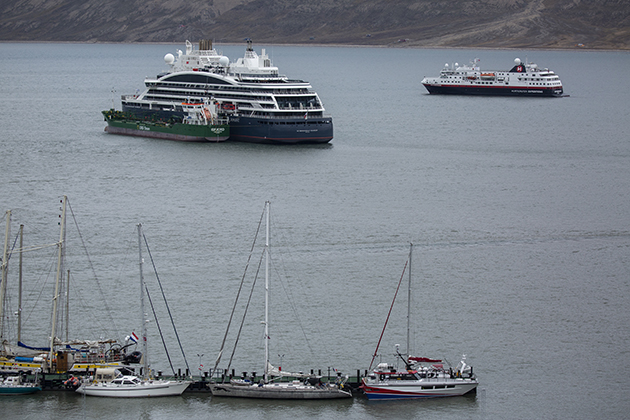 Yachts moored close to cruise ships