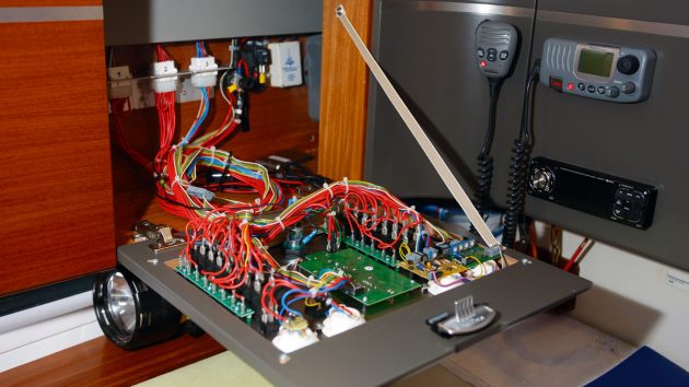 electrical cabling on a boat behind a panal