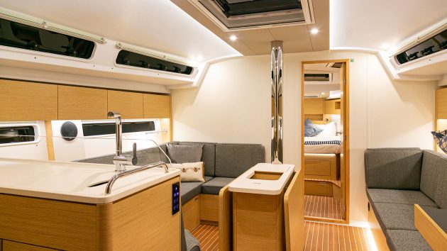 The interor has many wood finishes, including a cushioned bench behind a rectangular table.