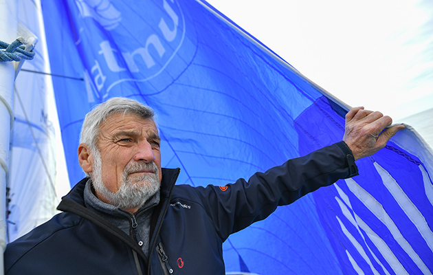 French sailor Jean Luc Van Den Heede leans on a blue sail