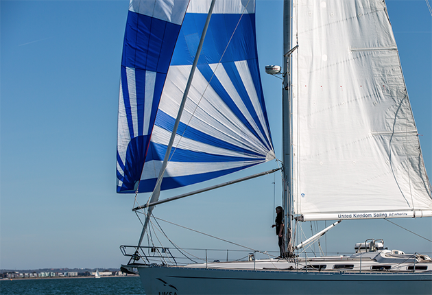 A blue and white spinnaker on a yacht